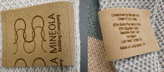 Etched Alcantara label on a knit blanket, showing the logo on the front and care details on the back